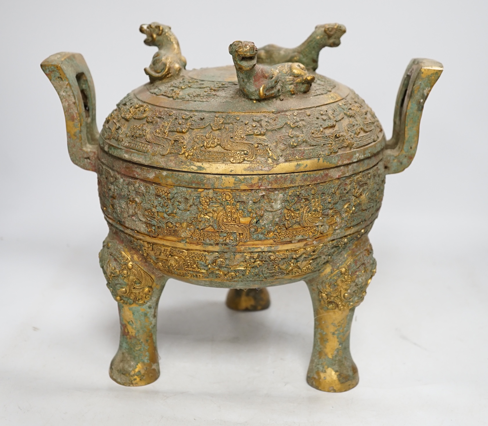 A Chinese archaistic bronze tripod censor and cover with tiger finials, height 18cm. Condition - fair for age